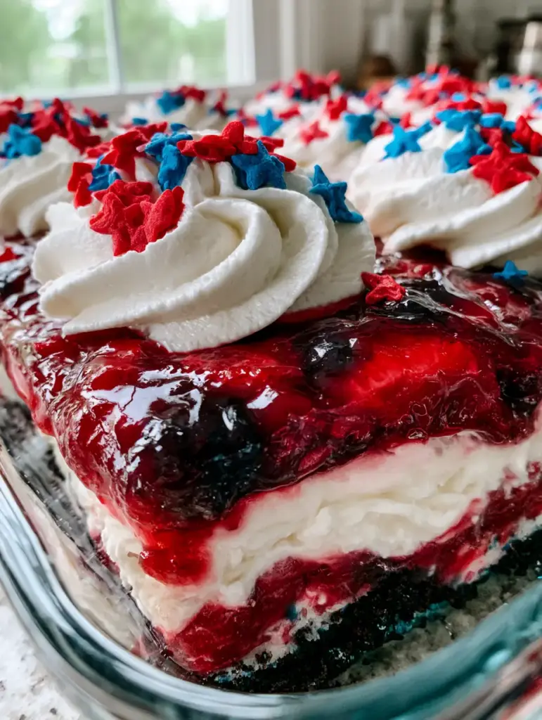 Lasaña Dulce de Frutos Rojos: El Postre Sin Horno Más Espectacular 2 Foto de cerca de la lasaña dulce mostrando la textura del glaseado de fresa y los rosetones de crema batida. (lasaña dulce)